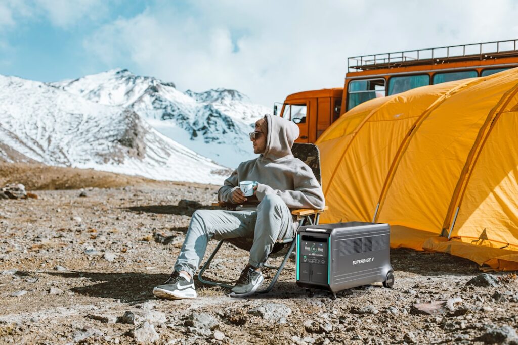 Portable power station beside a tent at a campsite